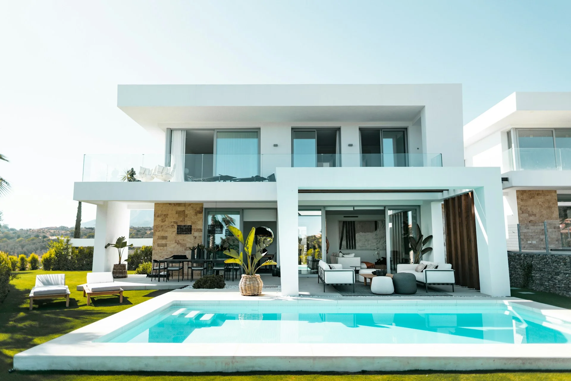 Calm blue swimming pool beside a contemporary stone terrace
